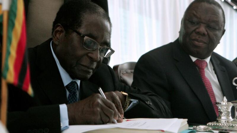 President and prime minister: Robert Mugabe and Morgan Tsvangirai in 2013. Photograph: Jekesai Njikizana/AFP/Getty