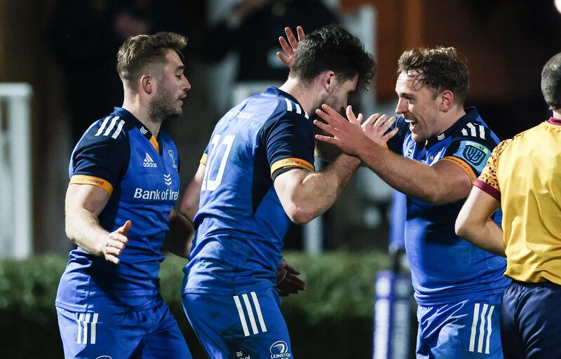 Leinster's Harry Byrne is congratulated by Jordan Larmour and Liam Turner after scoring his side's fourth try. Photograph: Tom Maher/Inpho