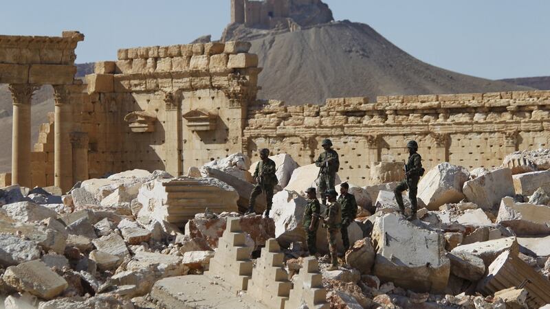 Syrian army soldiers stands on the ruins of the Temple of Bel in the historic city of Palmyra. Photograph: Omar Sanadiki/Reuters