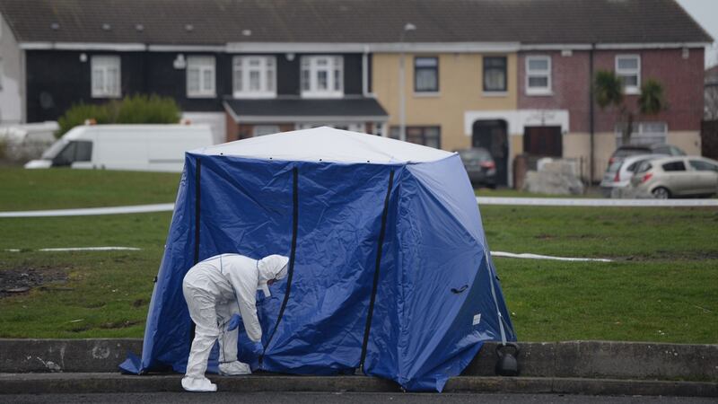 Gardaí at the scene in Coolock on Tuesday morning where a bag containing human limbs was found. Photograph: Dara Mac Dónaill