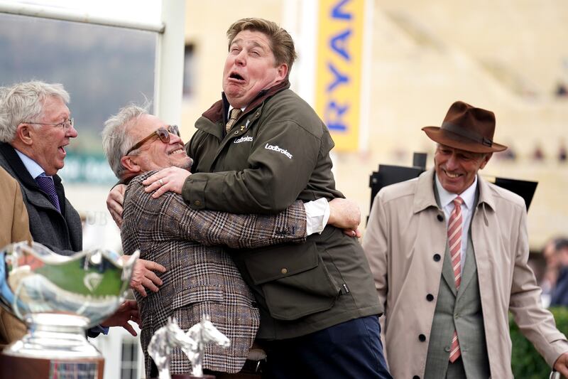 Dan Skelton celebrates with joint owner of Protektorat, Ged Mason, as Alex Ferguson looks on following their victory in the Ryanair Steeple Chase. Photograph: Mike Egerton/PA Wire.
