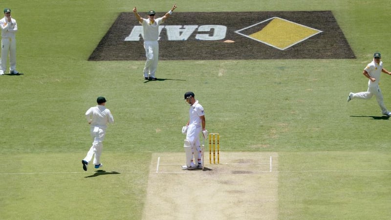 England’s Jonathan Trott (centre)  after losing his wicket to the bowling of Australia’s Mitchell Johnson (not pictured)  at The Gabba. Photograph: Anthony Devlin/PA Wire