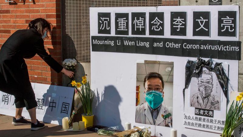 Chinese students and their supporters at a memorial in Westwood, California, for Dr Li Wenliang, the coronavirus whistleblower in Wuhan who died after contracting the virus. Photograph: Mark Ralston/AFP via Getty Images
