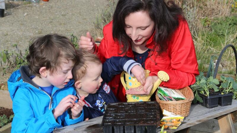 Sow and grow: Ailish Drake in her garden with her two sons Sam and Michael. Photograph: Liam Burke/Press 22