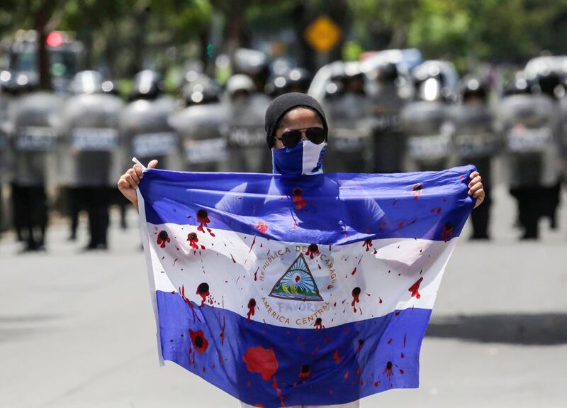 Protests: a demonstrator shows a bloody flag in September last year. Photograph: Inti Octon/AFP/Getty