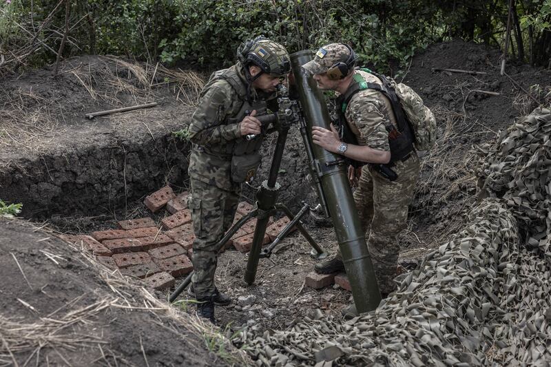 Members of a mortar team with the 24th Mechanised Brigade of the Ukrainian military prepare to fire on a Russian trench position in the Donetsk region of Ukraine. Photograph: Finbarr O’Reilly/New York Times
                      