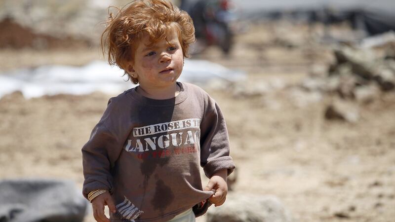 A displaced Syrian boy from the Daraa province fleeing shellings by pro-government forces waits in a makeshift camp in the province of Quneitra, near the border with the Israeli-occupied Golan Heights, on June 22nd. Photograph: Mohamad Abazeed/AFP