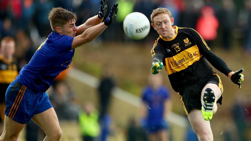Dylan Quinn tries to block Colm Cooper during Dr Crokes win over St Finbarr’s. Photograph: James Crombie/Inpho