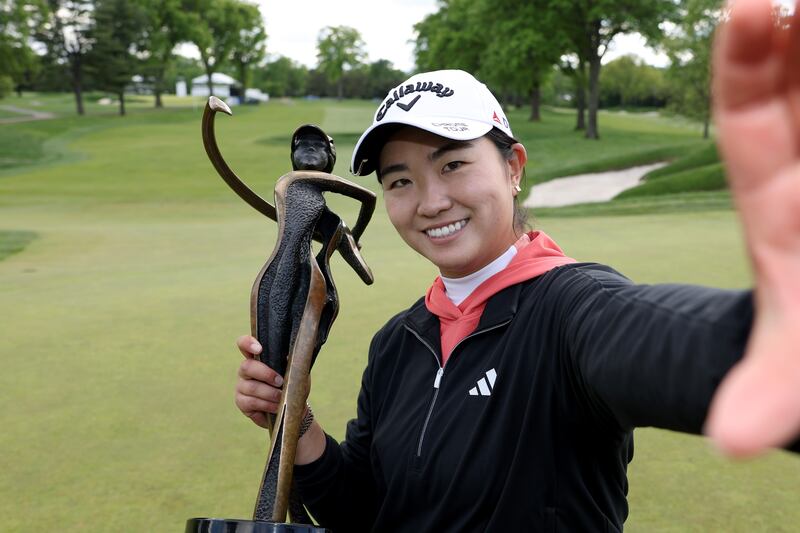 Rose Zhang imitates taking a selfie with the trophy after winning the Cognizant Founders Cup at Upper Montclair Country Club in Clifton, New Jersey. Photograph: Elsa/Getty Images