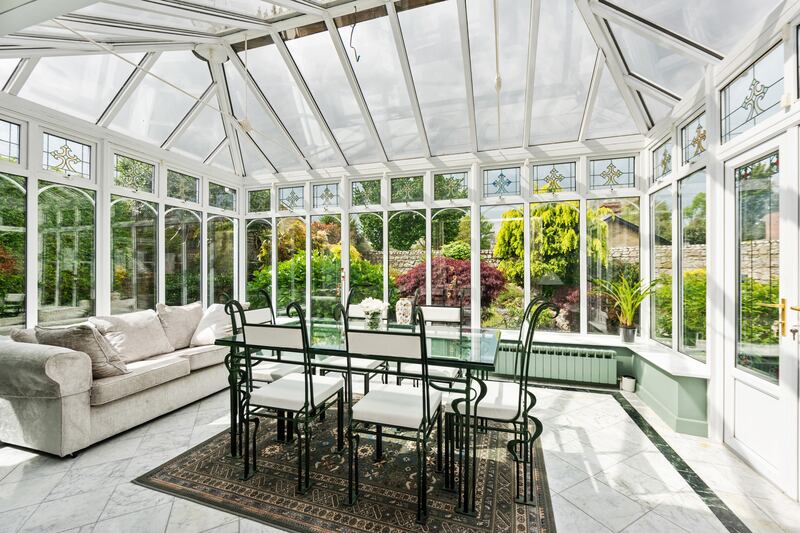 Sunroom: French doors open onto a terrace bordered by an old stone wall that makes a perfect spot for summer breakfasts.