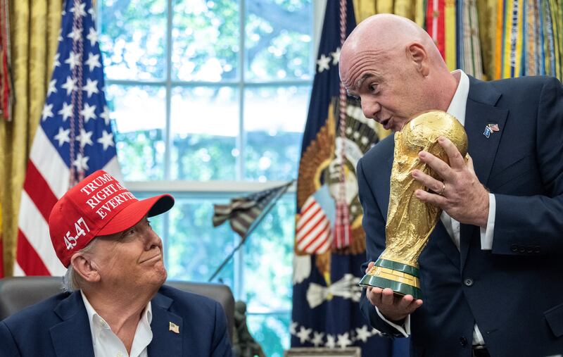 Fifa president Gianni Infantino (R) hands the World Cup trophy to Donald Trump in the Oval Office of the White House. Photograph: ANDREW CABALLERO-REYNOLDS/AFP via Getty Images          