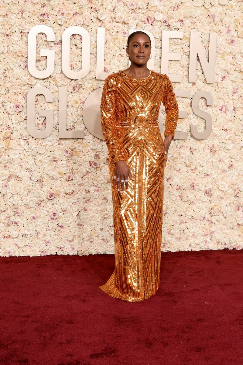 Issa Rae attends in a glittering, gold, floor-length gown. Photograph: Amy Sussman/Getty Images
