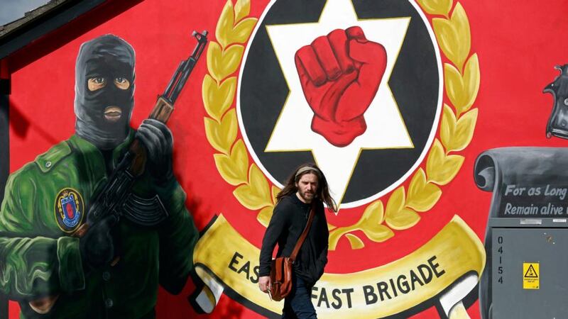 A man walks past a mural in east Belfast. Britain has said that all parties in Northern Ireland will begin talks on Monday, led by the British and Irish governments. Photograph: Cathal McNaughton/Reuters