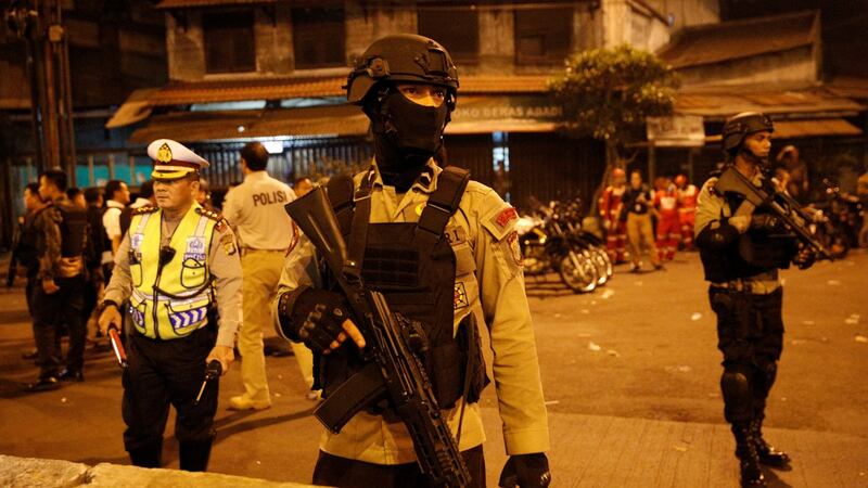 Police stand guard at the scene of  explosions in Jakarta, Indonesia. Photograph: Darren Whiteside/Reuters
