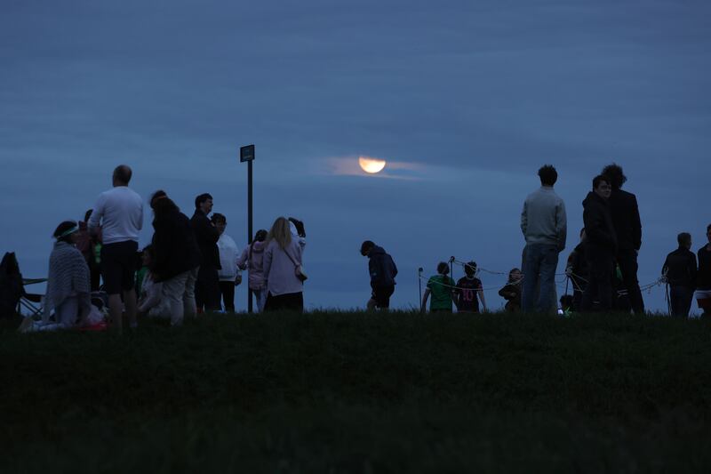 Visitors under the moonlight on the Hill of Tara. Photograph: Alan Betson