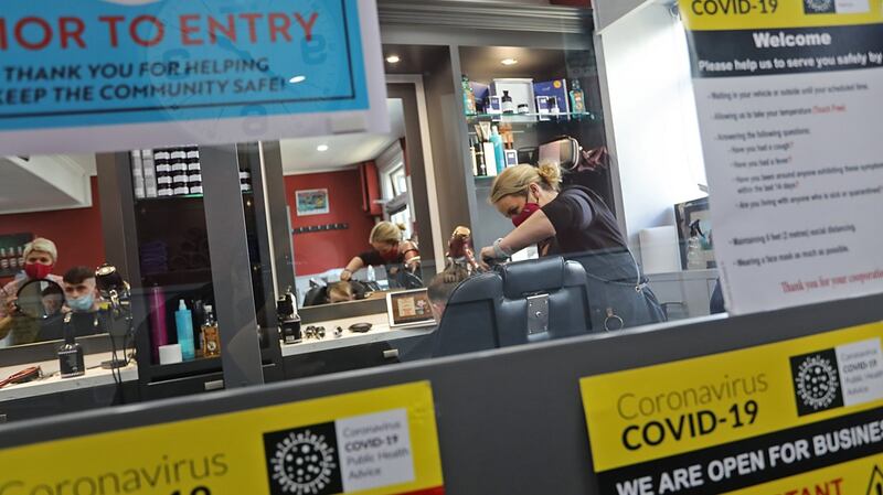 Barber Lorraine O’Neill orks on her last customer prior to shutting down her barber shop in Cavan town on Thursday. Photograph: Lorraine Teevan