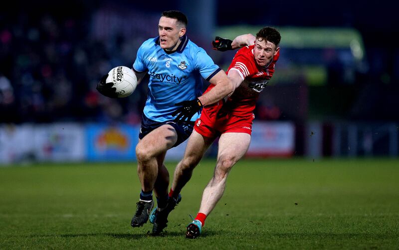 Dublin's Brian Fenton is tackled by Derry’s Lachlan Murray at Celtic Park. Photograph: Ryan Byrne/Inpho 