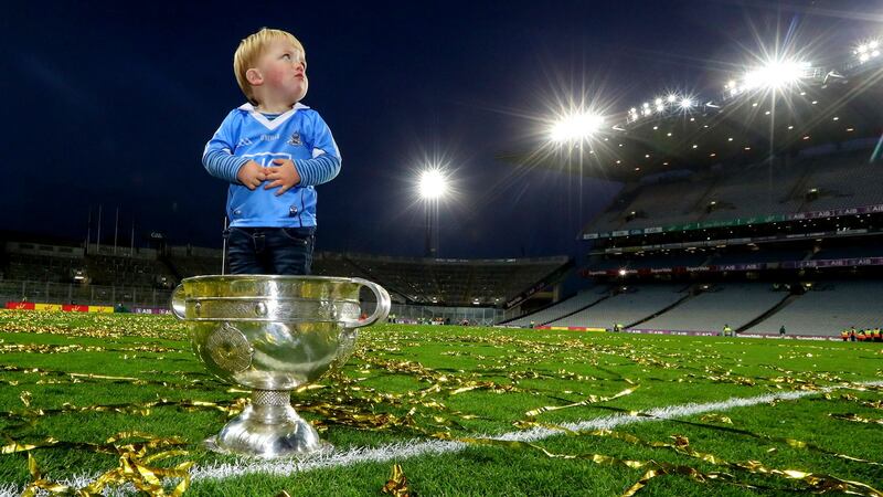 Denis Bastick sons Aidan in the Sam Maguire after Dublin beat Mayo in the 2016 final replay. Photo: James Crombie/Inpho