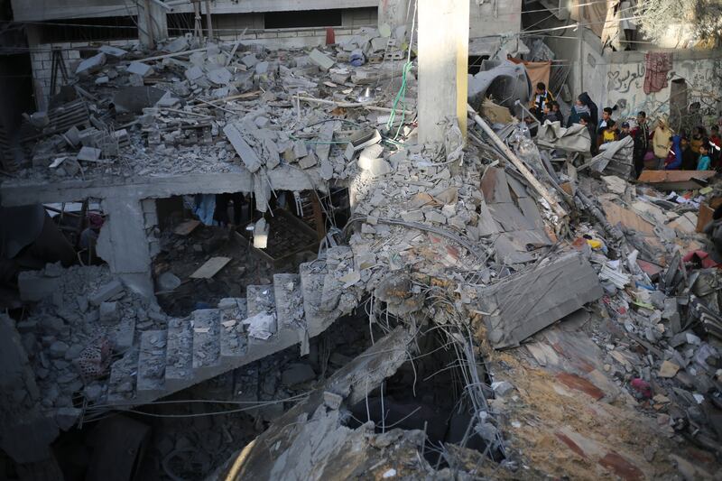 Palestinians look at the destruction after an Israeli strike in Rafah, Gaza Strip. Photograph: Hatem Ali/AP