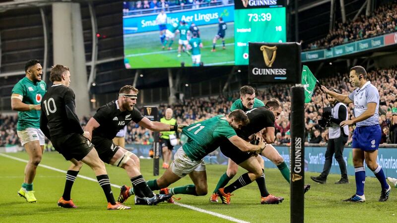Jacob Stockdale and Jonathan Sexton force Ben Smith and Kieran Read into touch. Photo: Gary Carr/Inpho
