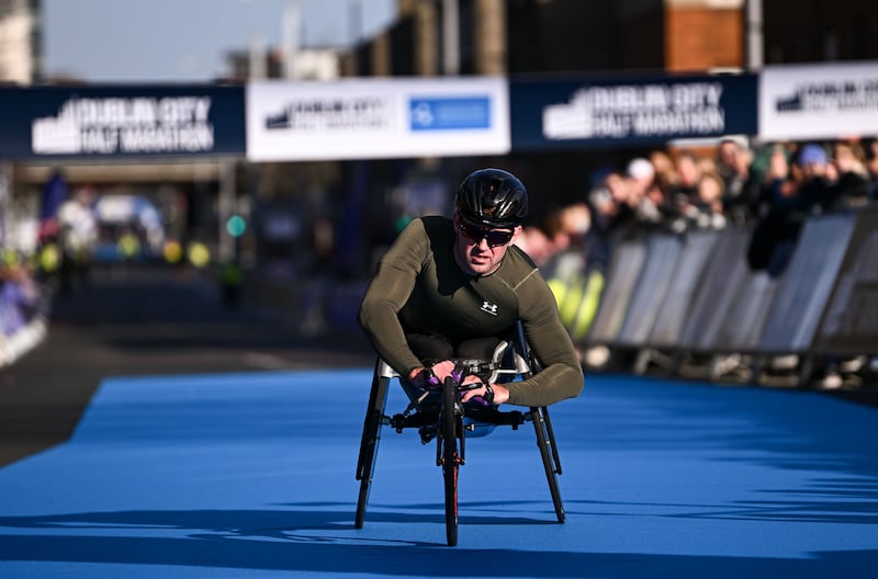 Patrick Monahan crosses the line to win the wheelchair race. Photograph: Ramsey Cardy/Sportsfile