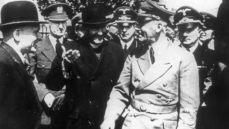 Hans Globke (in the background with eyeglasses)  in March 1939 during the German occupation of Bohemia and Moravia. Photograph: b Sovfoto/Universal Images Group via Getty Images