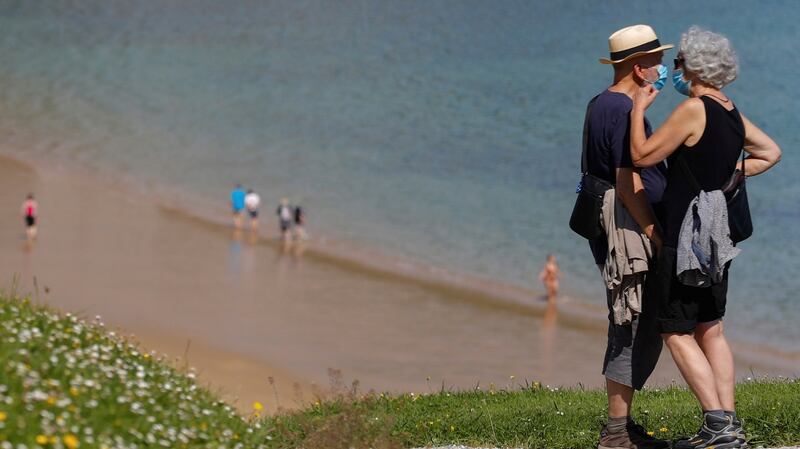 Residents go for a walk at Ondarreta beach in San Sebastian, Basque country, Spain. Photpgraph: Juan Herrero/EPA