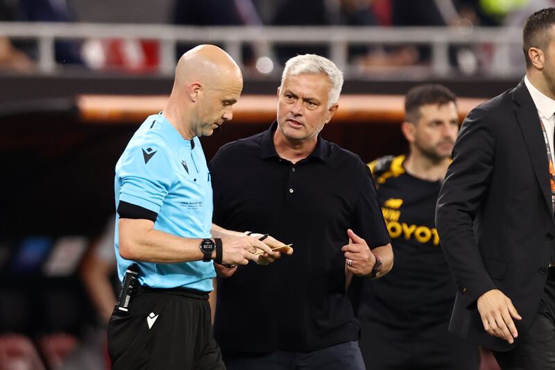 Roma manager Jose Mourinho interacts with referee Anthony Taylor during the Europa League final against Sevilla at Puskas Arena in Budapest. Photograph: Naomi Baker/Getty Images
