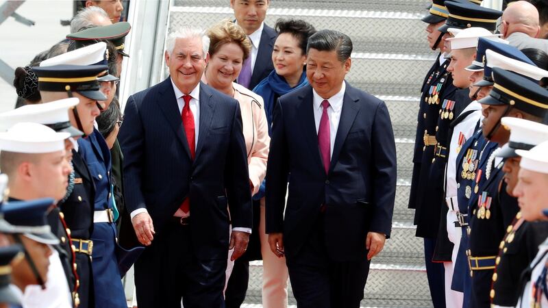 US secretary of state Rex Tillerson walks with China’s president Xi Jinping at Palm Beach International Airport in Florida. Also pictured is Mr Tillerson’s wife, Renda, beside Mr Xi’s wife Peng Liyuan.
