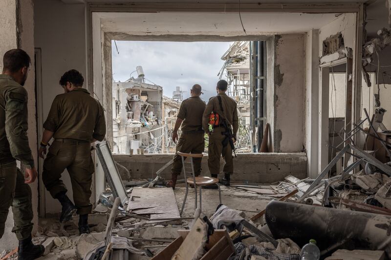 Israeli solders survey the destruction following an Iranian missile attack in Bat Yam, Israel, on Tuesday, June 24th, 2025. US president Donald Trump lashed out at Israel and Iran for launching attacks after he had announced a ceasefire. Photograph: Avishag Shaar-Yashuv/The New York Times
                      