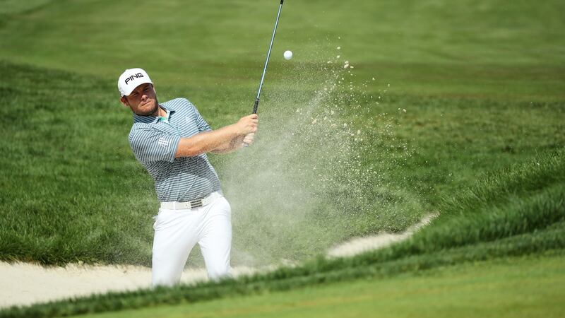 Tyrrell Hatton   plays a shot from a bunker on the 12th hole during the first round of the BMW Championship at Aronimink Golf Club. Photograph: Gregory Shamus/Getty Images