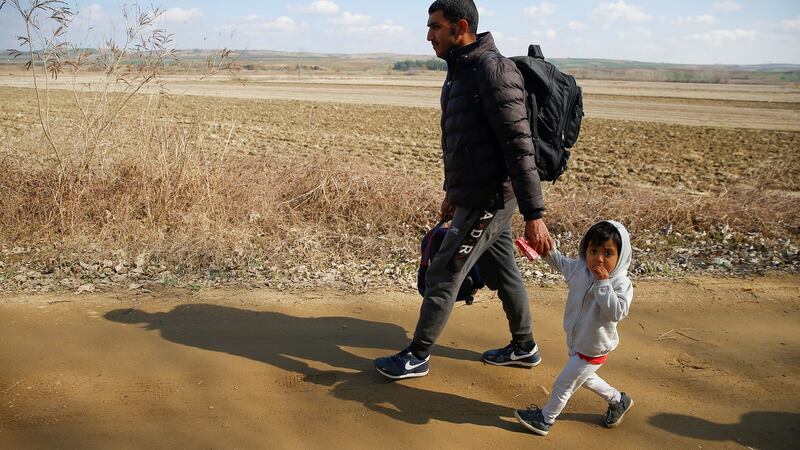 Migrants arrive to cross the Evros river to reach Greece as they are pictured from the Turkish border village of Elcili, Turkey on Sunday. Photograph: Huseyin Aldemir/Reuters
