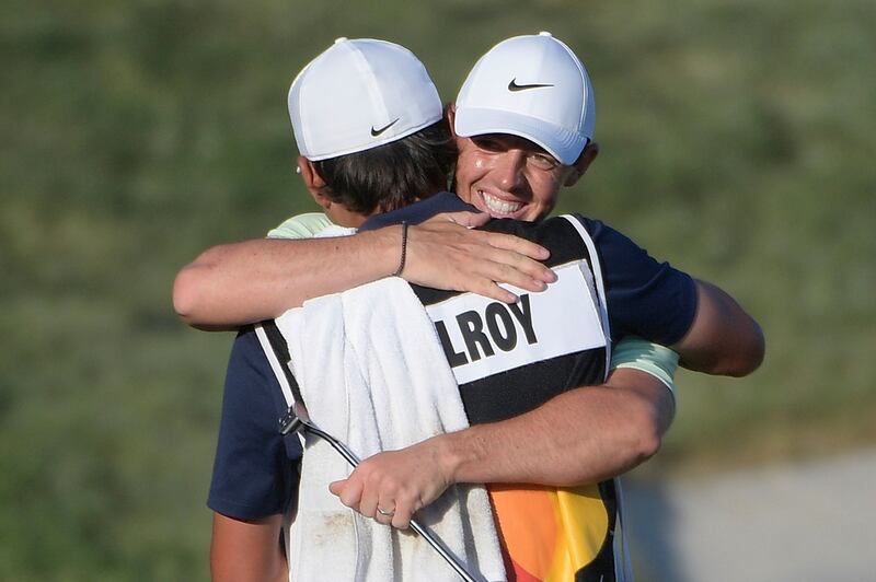 McIlroy hugs caddie Harry Diamond after the pair racked up a first win together. Photo: Phelan M. Ebenhack/AP Photo