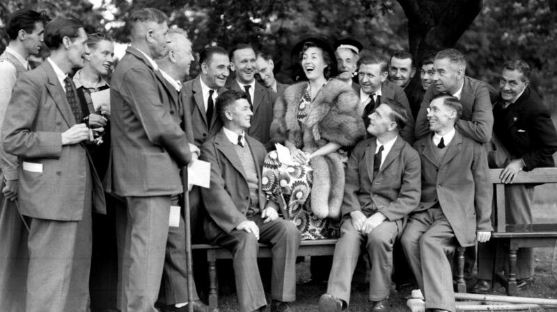 Vera Lynn with ex-servicemen during a garden party held by Queen Elizabeth at Buckingham Palace, in 1950. File photograph: PA/PA Wire