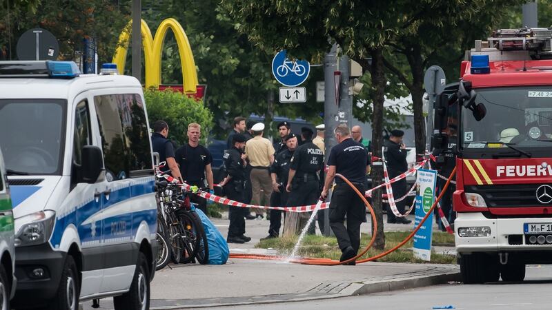 Police and fire services clean at the scene of the mass  shooting in Munich on Friday.  Photograph: Joerg Koch/Getty Images