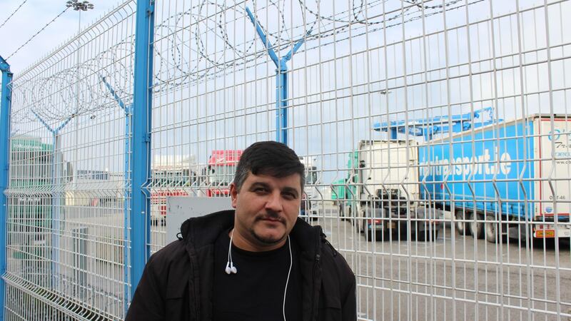 Lorry driver Nic Sterian, who works for Wexford firm P&D Foley Transport, standing along the barbed wire fence of Cherbourg port: “If you stop 100km from any port in France it’s a problem with the migrants.” Photograph: Jack Power