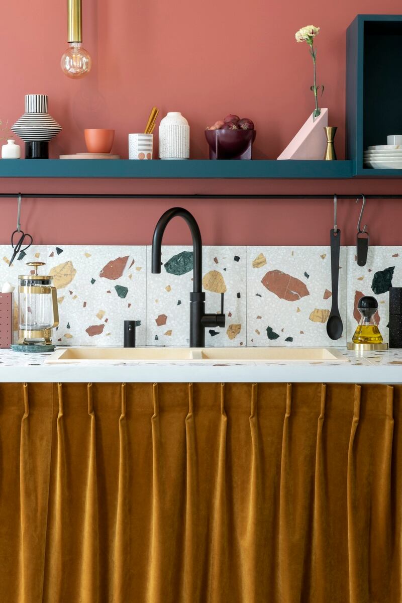 A curtain cupboard door, with pin-tuck detailing, and a Quooker tap