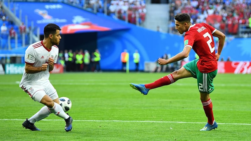 Morocco’s Achraf Hakimi has a shot at goal as Iran’s Morteza Pouraliganji attempts to block during  the World Cup game in St Petersburg. Photograph: Dylan Martinez/Reuters