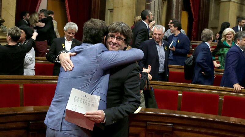 Catalan regional government president Carles Puigdemont is embraced by a colleague after the Catalan assembly approved a declaration of independence in Barcelona. Photograph: Alberto Estevez/EPA