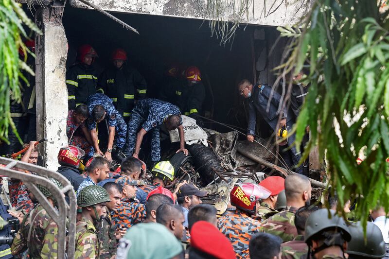Bangladesh's fire service and security personnel conduct a search and rescue operation after a Air Force training jet crashed into school in Dhaka on July 21, 2025. Photograph: Abdul Goni/AFP