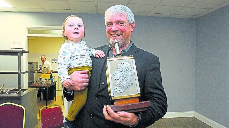 Séamus O’Rourke with his grandchild Fionn MacGowan (14 months) after receiving the Leitrim Guardian person of the year award. Photo: Leitrim Observer