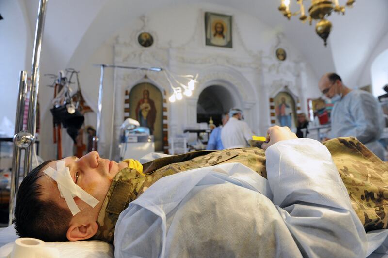 A Maidan protester wounded in clashes with police in 2014 rests inside a makeshift hospital in St Michael’s monastery in Kyiv. Photograph: Yuriy Dyachyshyn/AFP 
