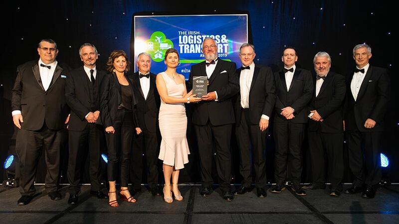 Seamus Kavanagh, Awards Judge presents the Passenger Transport SME Company of the Year award to the Swords Express team.