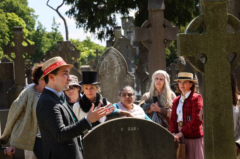 A visit to the grave of Matthew F Kane as part of the Joycean walking tour of Glasnevin Cemetery with tour guide Daniel Carey (left). Photograph: Dara Mac Dónaill






