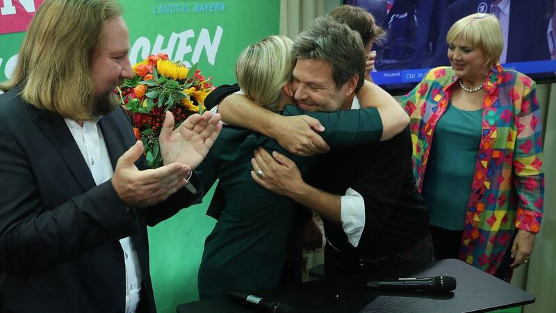 Katharina Schulze and Ludwig Hartmann, co-lead candidates of the Bavarian Green Party embrace as leading members of the federal Green Party Anton Hofreiter (left) and Claudia Roth look on in Munich, Germany. Photograph: Sean Gallup/Getty Images
