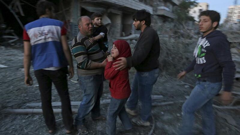 A family reacts amidst damage after surviving what activists said was a barrel bomb dropped by forces loyal to Syria’s president Bashar al-Assad in the Al-Qatrgi area of Aleppo. Photograph: Hamid Khatib/Reuters