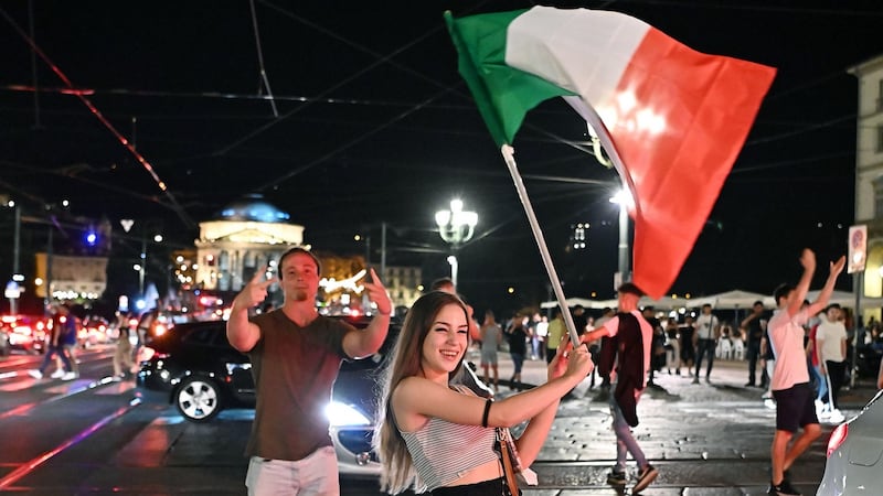 Italian fans do some celebrating of their own in Turin. Photograph: Alessandro Di Marco / EPA