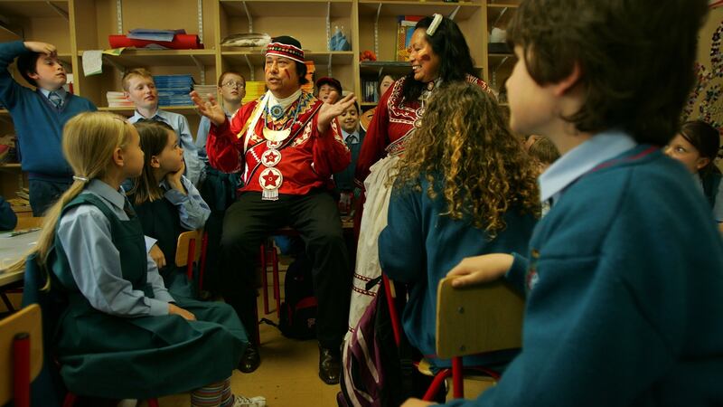 Gary and Janie White Deer of the Choctaw nation in Oklahoma talk to pupils of  Gaelscoil Cholmcille, Santry, Dublin. about  the Irish famine in 1847, when their ancestors sent $170 in aid. Photograph: Kate Geraghty