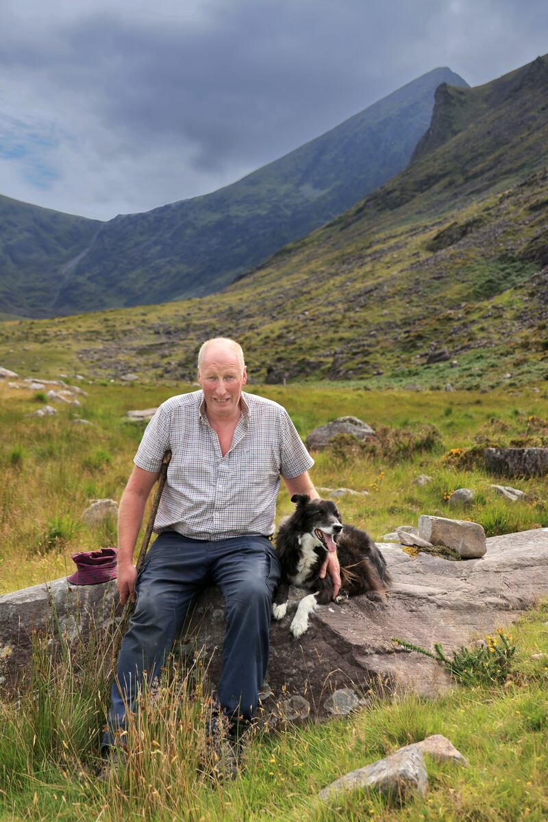 Davy Leane of Coolroe with his dog Max on the foothills of the MacGillycuddy’s Reeks with Carrauntoohil in the background. Photograph: Valerie O'Sullivan