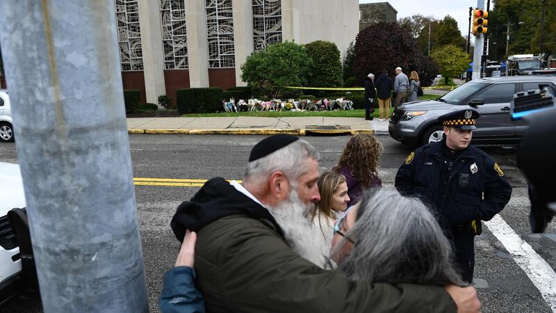 People embrace in front of a memorial on October 28th, 2018 outside the Tree of Life Synagogue in Pittsburgh  after a shooting there left 11 people dead. Photograph: Brendan Smialowski / AFP/ Getty Images